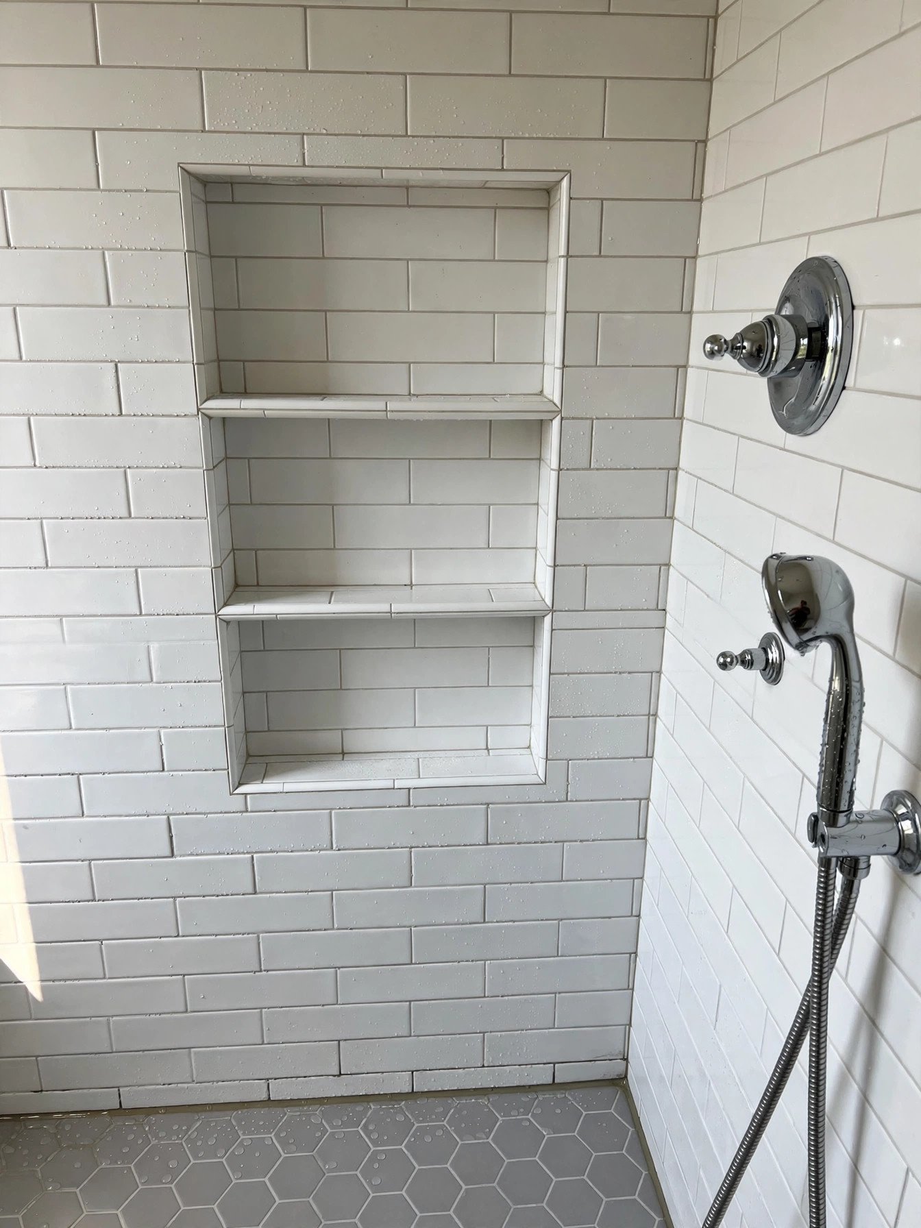Freshly tiled walk-in shower with niche in a renovated Pitt Meadows BC bathroom